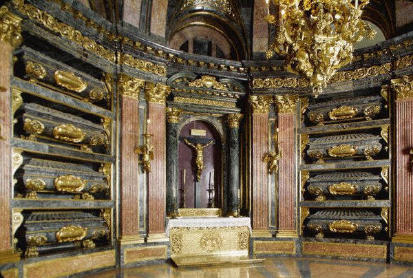 coffins containing spanish kings and queens are set into the walls of the Pantheon of the  Kings in the monastery of El Escorial